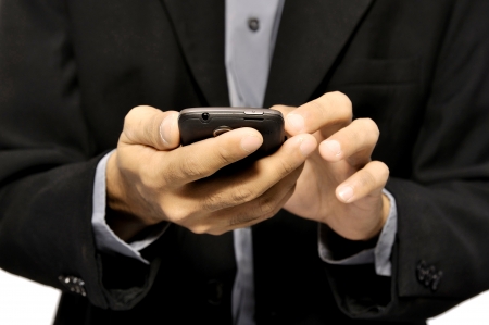 Close up of man using mobile smart phone isolated on white backgroundの写真素材