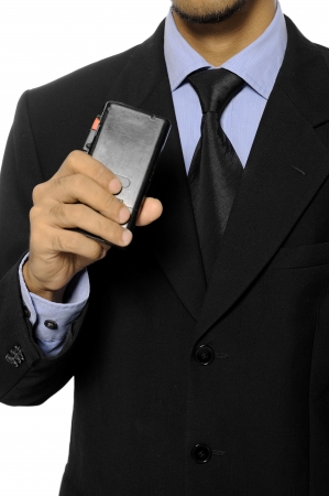 Businessman speaking into a dictaphone recorder isolated over white backgroundの写真素材