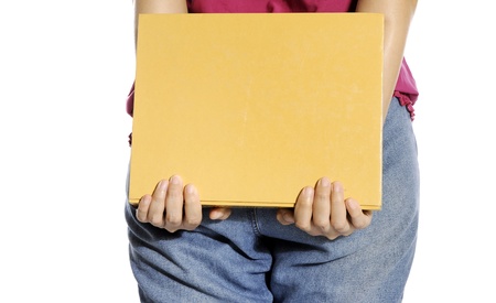 Woman bring book with her hand isolated over white backgroundの写真素材