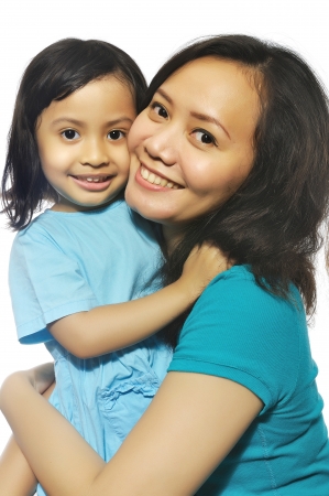 Portrait of happy mother and daughter isolated over white backgroundの写真素材