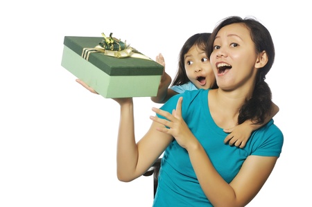 Portrait of happy mother and daughter holding box isolated over white backgroundの写真素材