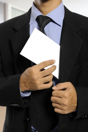 Business man showing blank envelope. You can put your message on the envelopeの写真素材