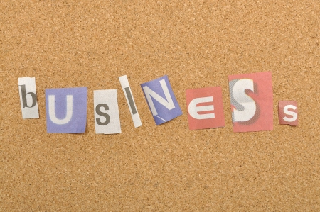 Business word made from newspaper letter shot over pinboard backgroundの写真素材