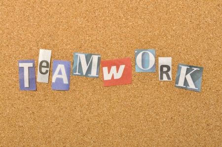 Teamwork word made from newspaper letter shot over pinboard backgroundの写真素材