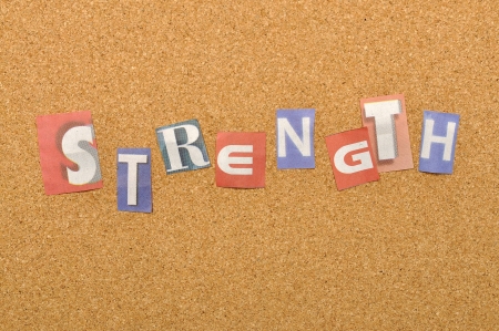 Strenght word made from newspaper letter shot over pinboard backgroundの写真素材