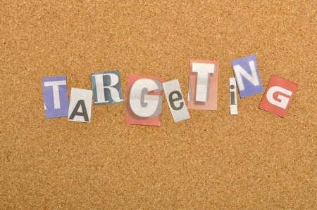 Targeting word made from newspaper letter shot over pinboard backgroundの写真素材