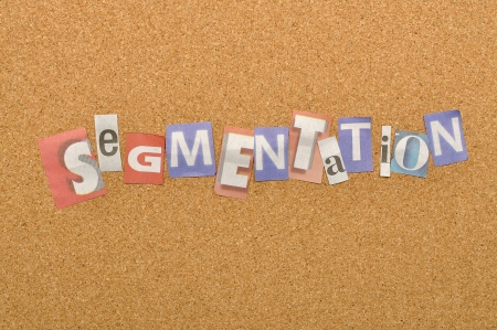 Segmentation word made from newspaper letter shot over pinboard backgroundの写真素材