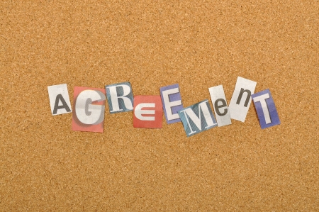 Agreement word made from newspaper letter shot over pinboard backgroundの写真素材