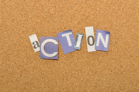 Action word made from newspaper letter shot over pinboard backgroundの写真素材