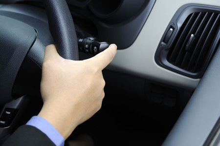 Business man wearing business suit driving a car.
