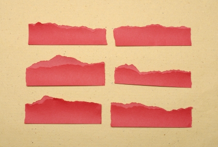 Collection of red paper tears, shot on brown backgroundの写真素材