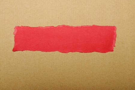 Red paper tears, shot on brown backgroundの写真素材