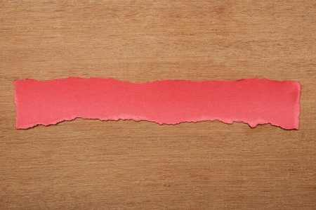 Red paper tears, shot on wooden backgroundの写真素材