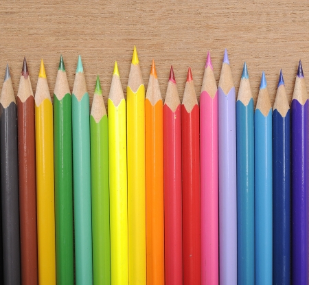 Colour pencils shot on wooden background close upの写真素材