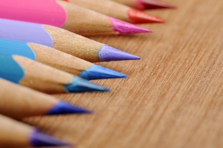 Colour pencils shot on wooden background close upの写真素材