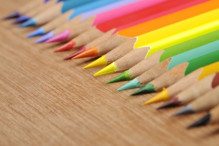 Colour pencils shot on wooden background close upの写真素材