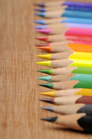 Colour pencils shot on wooden background close upの写真素材