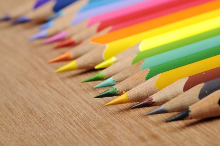 Colour pencils shot on wooden background close upの写真素材