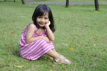 Cute little girl on the park in the summer timeの写真素材
