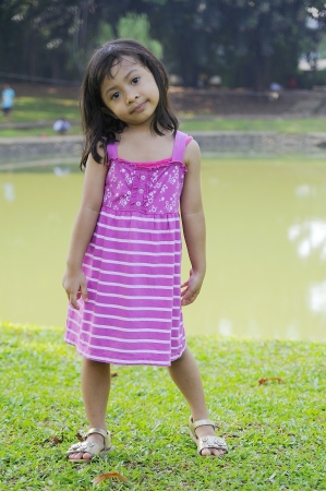 Cute little girl on the park in the summer timeの写真素材