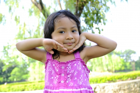 Cute little girl on the park in the summer timeの写真素材