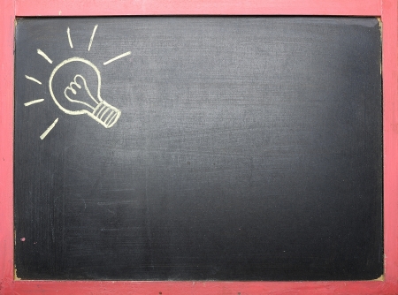 Idea lamp drawing at black chalkboard backgroundの写真素材