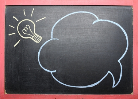 Idea lamp drawing with cloud bubble at black chalkboard backgroundの写真素材
