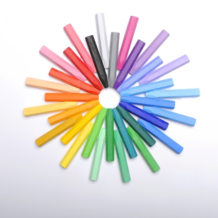 Row of colorful crayon making circle shape over white backgroundの写真素材