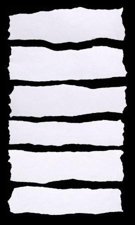 Pieces of torn white paper on black background. You can put your message on the paperの写真素材