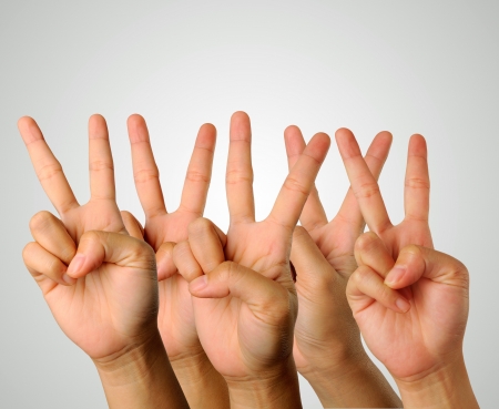 Hands showing the sign of victory and peace closeupの写真素材