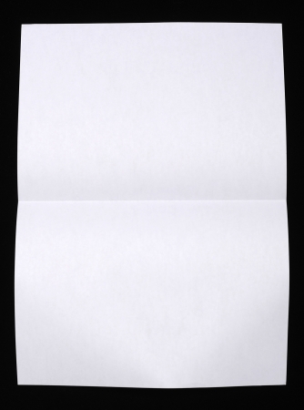 Sheet of paper folded onver black backgroundの写真素材