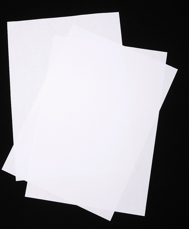 Sheet of paper folded onver black backgroundの写真素材