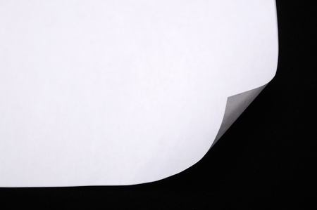 Sheet of paper folded onver black backgroundの写真素材