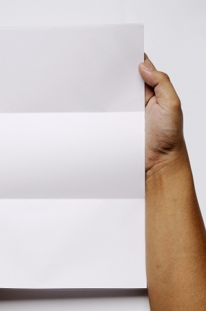 Male hand holding folded blank A4 copy space letterの写真素材