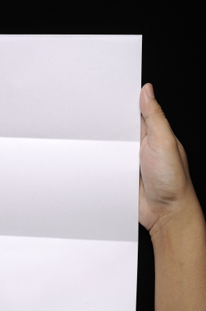 Male hand holding folded blank A4 copy space letterの写真素材