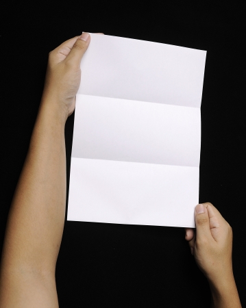 Male hand holding folded blank A4 copy space letterの写真素材