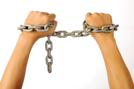 Man's hands tied with chains isolated over white backgroundの写真素材