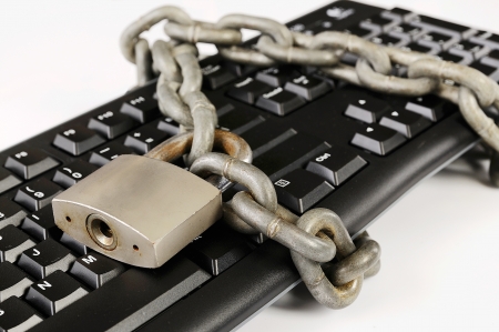 Computer keyboard tied with chain. A computer security conceptの写真素材