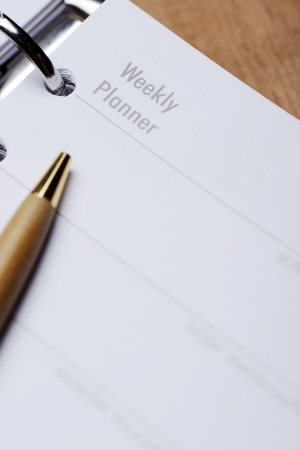 Open agenda with pen on wooden backgroundの写真素材