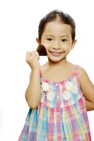 Portrait of pretty little girl with makeup isolated on white backgroundの写真素材