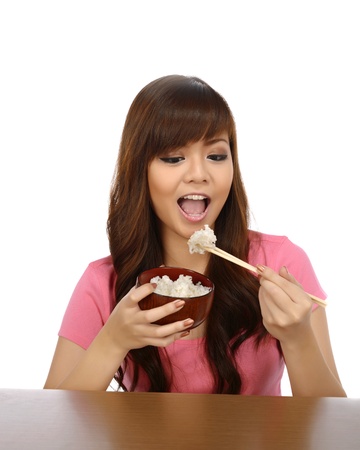 Beautiful asian woman eating japanese food with chopstick over white backgroundの写真素材