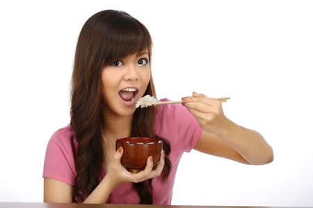 Beautiful asian woman eating japanese food with chopstick over white backgroundの写真素材