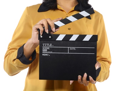 Young woman holding clapperboard isolated over white backgroundの写真素材