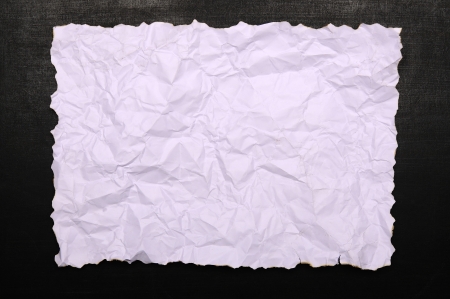 White burnt paper on chalkboard. You can put your design on the paperの写真素材