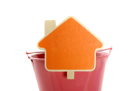 House shape sign made from wood on red metal bucket. You can put your design on the signの写真素材