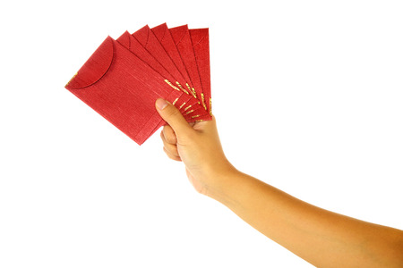 Hand holding chinese red envelope isolated over white backgroundの写真素材