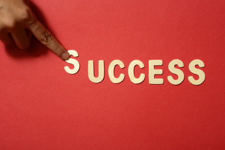 Success text on red paper backbround