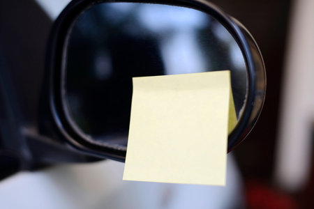 Blank yellow note on the car. You can put your message on the paper