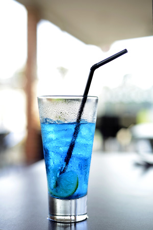 Blue iced lemon soda on the table in summerの写真素材