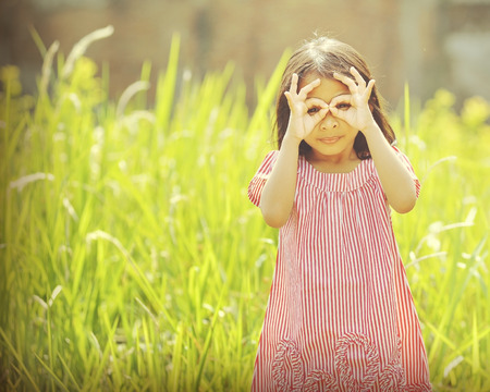 Happy asian girl playing outdoor in sunny day with retro styleの写真素材